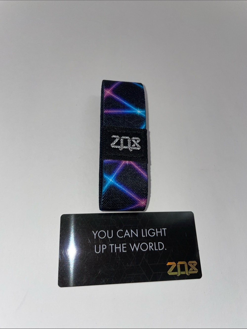 ZOX #00487.  Neon Laser Print Hand band.  Black with Blue & Purple Accents